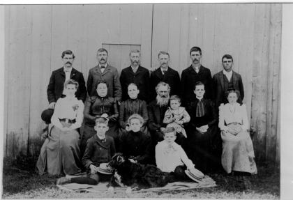 Back: Charlie, Elmer, West, Parley, Simon, Hubert. Middle Row: Viena, Florence, Grandma Adeline, Grandpa Henry, Inda, Bertha. Baby in Henry's lap is Raymond,…