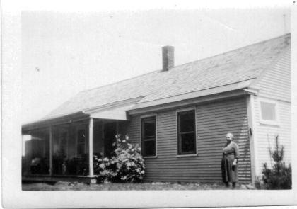 Lucia Hill in front of their house.